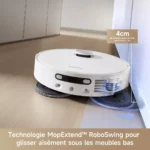 White robotic mop-vacuum gliding under low cabinetry with its mop pad deployed, showcasing the MopExtend RoboSwing technology in action on a wood floor.
