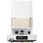 Dreame robotic vacuum with a white top and brushed gold midsection resting in its charging base.