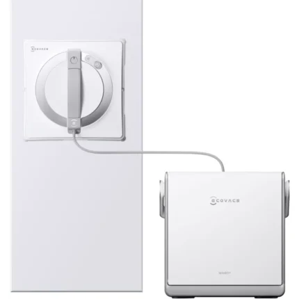 Robot window cleaner connected to a wall controller; round cleaning head mounted on a pane with a power unit attached by a cord (Covacs Winbot).