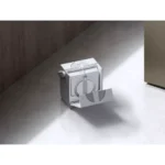 Small white mechanical box on a concrete floor with a circular dial and a hinged front panel open nearby door wall. Typical of a compact mechanical device or safe.