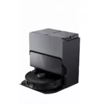 Roborock robotic vacuum resting in its charging dock (dark gray).