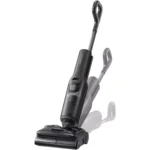 Cordless stick vacuum with tall adjustable wand and wide floor head, angled for use on a surface of view shown
