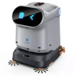Autonomous floor-cleaning robot with a curved black front panel, blue indicator lights, and orange side brushes.]}, {