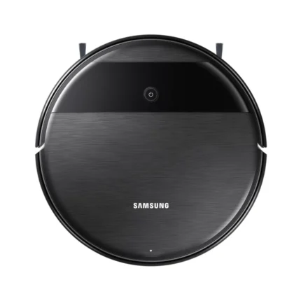 Round Samsung robotic vacuum from a top-down view with a brushed metal gray body and black band, showing its power button area and side brushes.