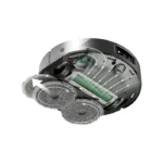 Cutaway view of a robotic vacuum showing rotating brushes, suction path, and airflow arrows illustrating how it cleans.