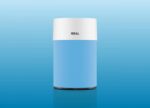 Blue cylindrical device with a white lid labeled IDEAL against a blue gradient background, product shot.