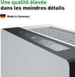 Close-up of a modern white toaster with a gray control panel and vented top; ad text reads 'Une qualité élevée dans les moindres détails' and 'Made in Germany'