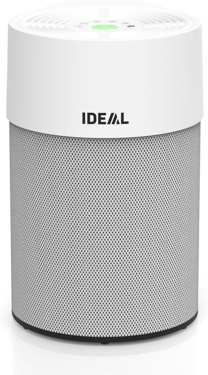 Tall white cylindrical air purifier with a perforated metal base and the IDEAL logo on the upper white housing; green indicator light on top.