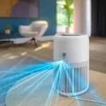 White cylindrical air purifier on a wooden floor, emitting blue light beams across the room with a modern living area in the background.