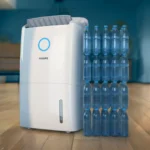 Philips water dispenser/purification unit with a rack of empty blue plastic water bottles beside it on a wooden floor 1/2