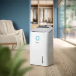 White Philips dehumidifier standing on a wooden floor in a modern living room, with a blue ring light on its front.