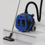 Blue portable pump unit with a flexible hose attached, positioned on white stair steps next to a floor vacuum head for removing water or liquids.