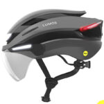 Grey Lumos bike helmet with built-in front white light and red rear light, plus visor and MIPS badge.
