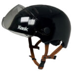 Black Kask open-face helmet with clear visor and brown leather chin strap, Italy-made.