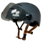 Kask-branded dark gray helmet with a clear visor and brown leather chin straps, viewed from the side.