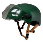 Green Kask helmet with clear face shield and brown chin straps, shown in side view for protective gear use.