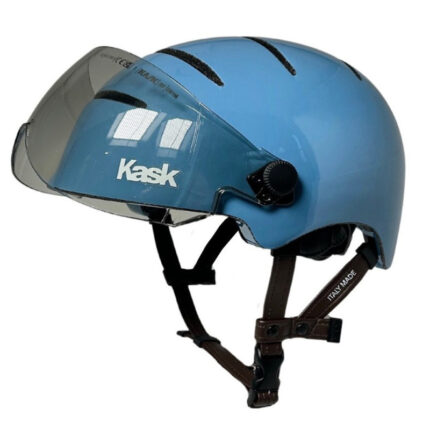 Blue Kask bicycle helmet with a clear, flip-down face shield and adjustable brown straps viewed from the side