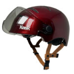 Maroon protective helmet with clear visor and brown adjustable straps, brand 'Kask' visible on the side—used for head protection in sports or riding