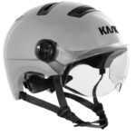 White motorcycle helmet with a clear, flip-up face shield and black adjustable straps (brand: KMI).