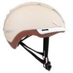 Beige Casco bike helmet in side profile with brown underside, small white visor, and black adjustable chin straps.