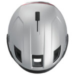 Top-down view of a silver bicycle helmet with black vents and red trim along the edge