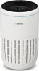 White cylindrical air purifier with vertical vent slits and a black circular control panel on top.