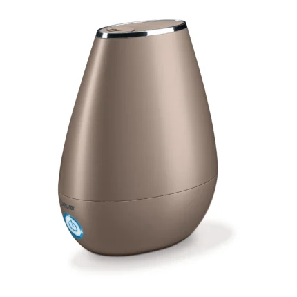 Close-up of a tan conical device with a chrome rim and a blue power button badge near the bottom, Beurer brand visible