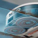 Close-up of a blue futuristic machine showing two spinning wheel-like discs with glowing blue rings and scattered rust particles in the air.