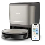 Philips robotic vacuum on a charging dock with a connected smartphone showing a home cleaning map.