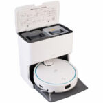 White autonomous vacuum with a docking/charging station, lid open showing compartments, and the robot resting on the mat in front.