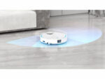 Autonomous white robot vacuum cleaning the floor, emitting a blue navigation glow.