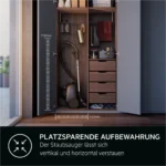 Open wardrobe showing a vacuum stored vertically with attached hose, hanging tools, and multiple drawers; space-saving storage emphasis in overlay text.