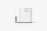 White compact printer with a top-loading slot, rounded front, and left-side venting against a light background.