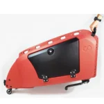 Red portable exercise machine frame with a large black panel, small wheels, and a hand lifting one end.