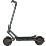 Gray electric scooter with tall adjustable handlebar, long deck, and orange accents on the wheels (urban commuter model).