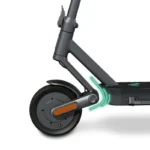 Close-up of an electric scooter's front wheel, fork, and deck with an orange side reflector.