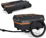 Bike cargo trailer with dark gray fabric, orange accents, and a large wheel, attached to a hitch.