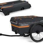 Bike cargo trailer with dark gray fabric, orange accents, and a large wheel, attached to a hitch.