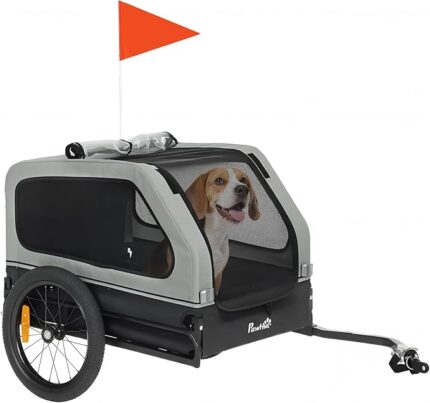 Pet bike trailer with two wheels and an orange flag, showing a happy dog inside a gray enclosure ready for a ride.