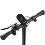 Electric scooter handlebar with a digital display unit in the center showing speed, brake levers on both ends, and a green brake cable running along the bar