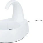 White electric pet water fountain with a curved spout and round basin, power cord visible in the background.