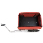 Red rectangular cargo box attached to a bicycle, forming a cargo bike setup with a black interior surface and a large wheel on the rear.