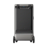 Grey hard-shell rolling suitcase with a recessed top handle and large wheels, designed for travel on varied terrain.