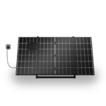 Solar panel mounted at an angle with a power cord plugged into a wall outlet on the left side.
