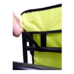 Close-up of a hand pulling a black strap to secure lime-green fabric on a folding chair frame.