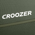 Close-up of olive-green fabric with a white 'CROOZER' logo.