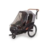 Two-wheeled bicycle child trailer with clear weather shield and gray canopy and brown frame