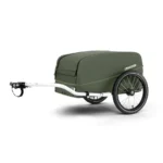 Green enclosed two-wheeled bicycle trailer with a white hitch, labeled Croozer, designed for cargo.