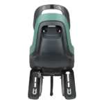 Rear-mounted child bike seat in green and dark gray with adjustable footrests and safety harness visible