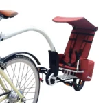 Rear child bicycle seat with harness and sun canopy mounted on a white bicycle.
